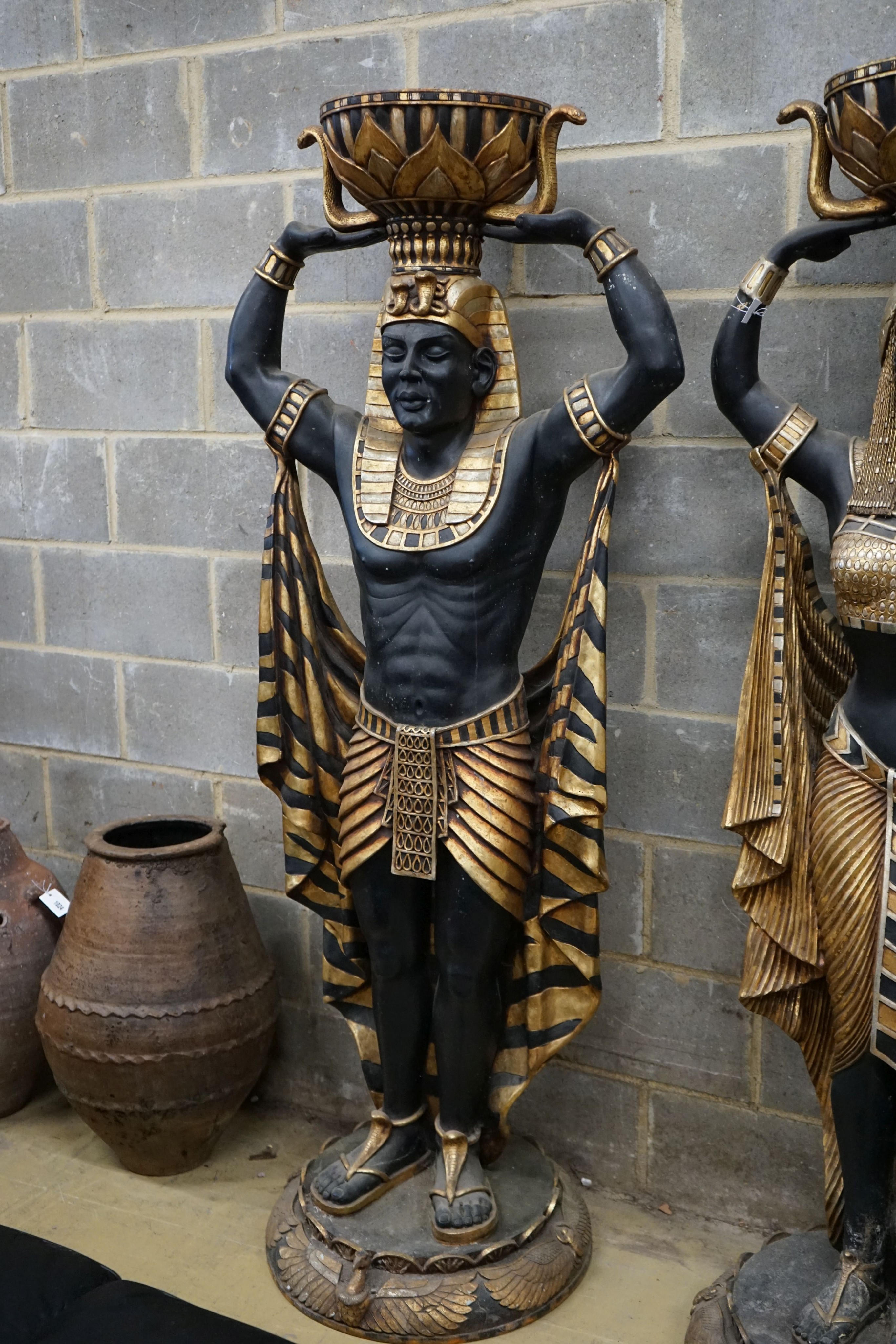 A pair of composition Egyptian style figural planters, height 185cm